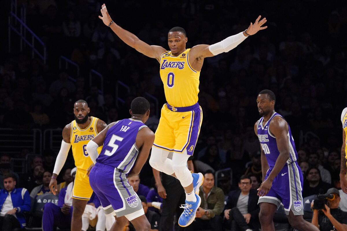 Los Angeles Lakers guard Russell Westbrook, second from right, jumps as he guards Sacramento Kings guard De'Aaron Fox