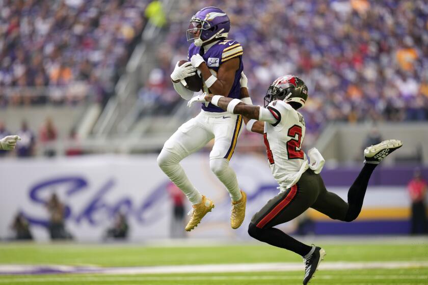 Minnesota Vikings wide receiver Justin Jefferson (18) catches a pass in front of Tampa Bay Buccaneers cornerback Carlton Davis III (24) during the first half of an NFL football game, Sunday, Sept. 10, 2023, in Minneapolis. (AP Photo/Abbie Parr)