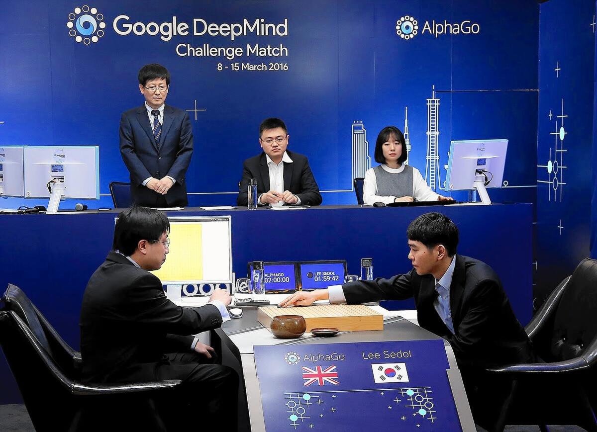 Lee Se-Dol, right, a legendary South Korean player of Go — an ancient board game developed in China that is more complex than chess — makes a move during the Google DeepMind Challenge Match in Seoul.