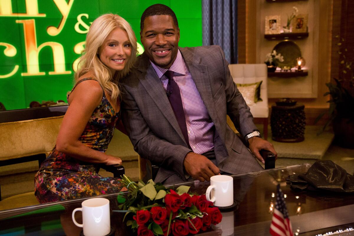 Kelly Ripa and Michael Strahan on the set of "Live With Kelly and Michael" in September 2012. Strahan is departing "Live" for "Good Morning America" this fall.