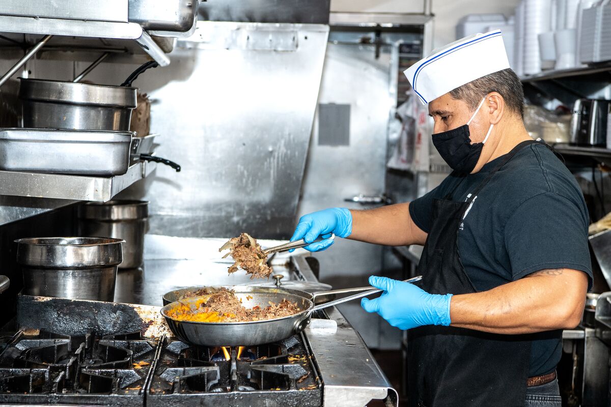 Longtime employee Roberto Rivera works inside the kitchen of Manuel's El Tepeyac Cafe in Boyle Heights.