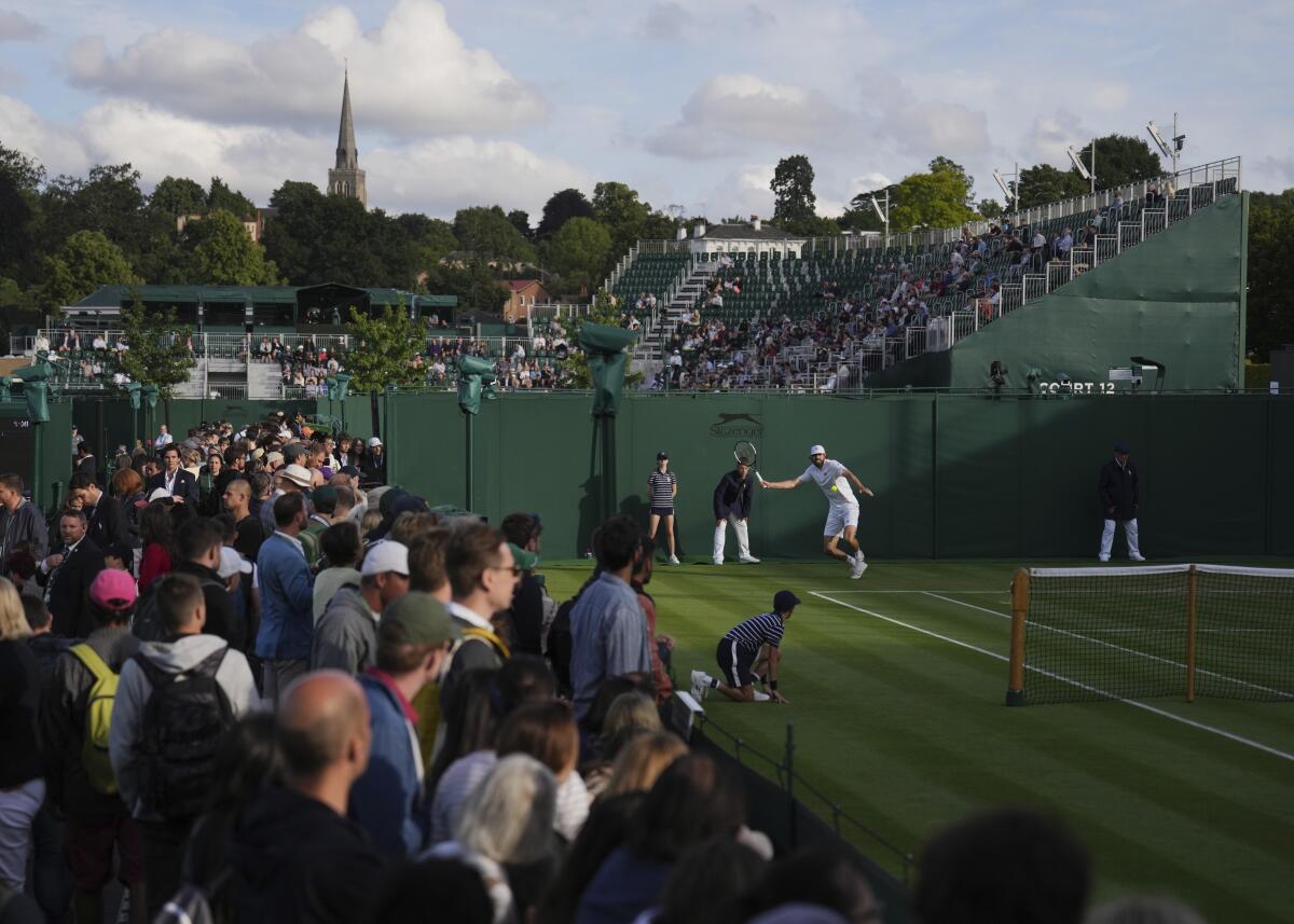 Reilly Opelka of the US plays a return to Tim van Rijthoven of the Netherlands in a second round men's singles match on day three of the Wimbledon tennis championships in London, Wednesday June 29, 2022. (AP Photo/Alberto Pezzali)