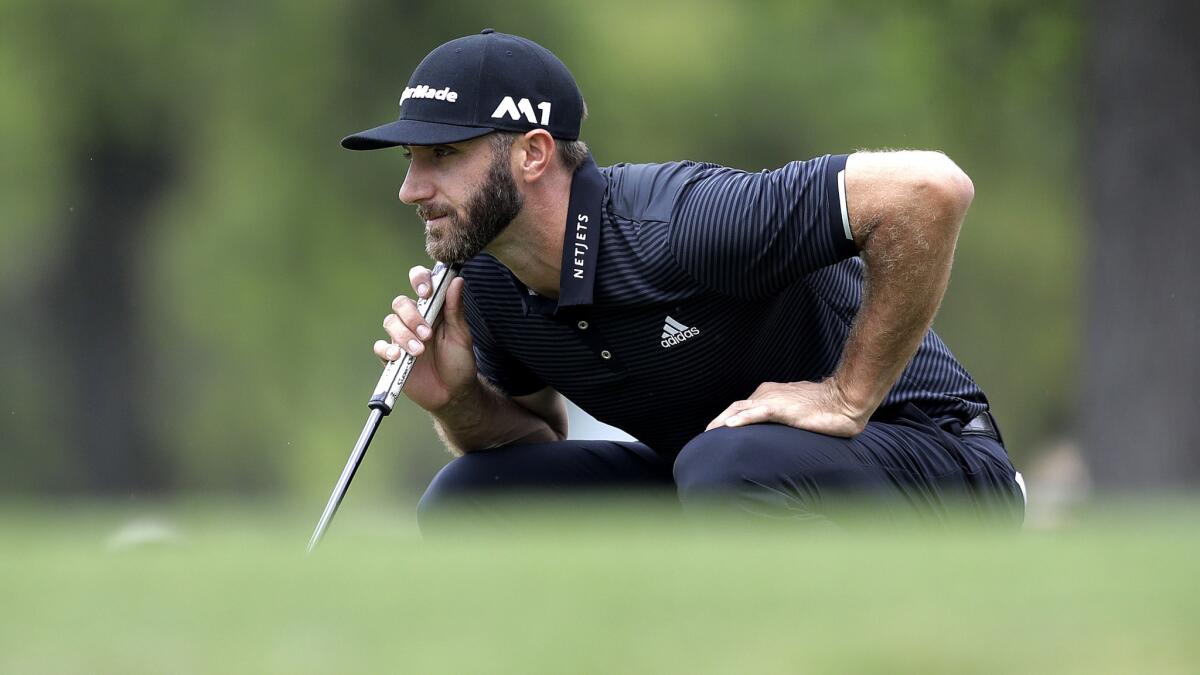 Dustin Johnson lines up a putt on the first hole during round-robin play at the Dell Technologies Match Play tournament on Friday. (Eric Gay / Associated Press)