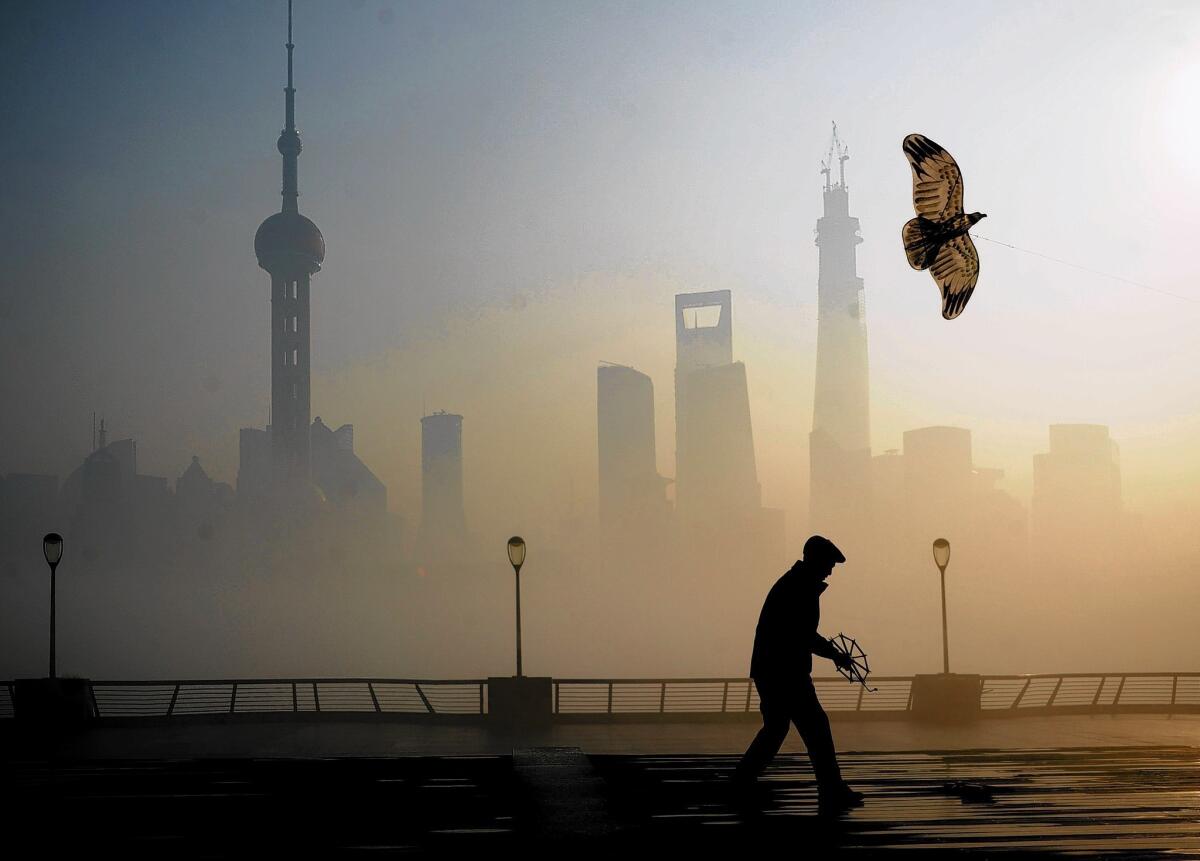 A man flies a kite in Shanghai. This month, the city had an air pollution reading of 500 for the first time, prompting authorities to order children and the elderly to remain indoors. Beijing and other parts of northern China have pollution that is even higher.