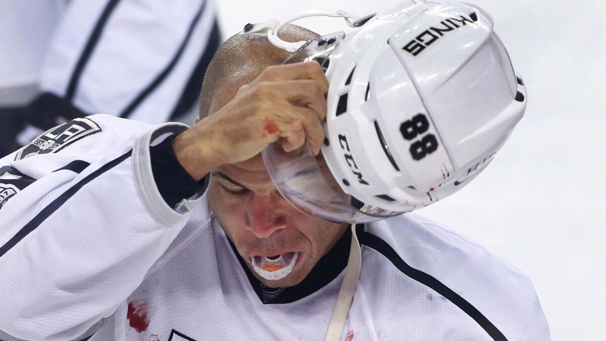 Kings' Jarome Iginla goes to the penalty box after a fight with Calgary's Deryk Engelland on March 29.