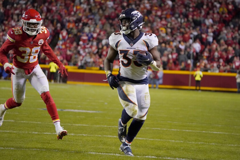 Denver Broncos running back Javonte Williams, right, runs past Kansas City Chiefs cornerback L'Jarius Sneed (38) on his way to a touchdown during the second half of an NFL football game Sunday, Dec. 5, 2021, in Kansas City, Mo. (AP Photo/Ed Zurga)