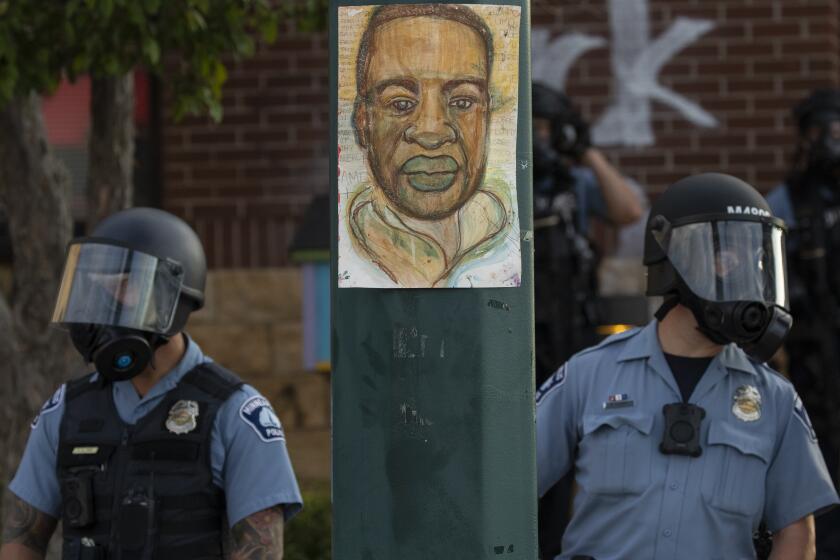 FILE - Minneapolis police stand outside the department's 3rd Precinct on May 27, 2020, in Minneapolis. Almost two years after George Floyd died at the hands of four Minneapolis police officers, Minnesota's Department of Human Rights was set Wednesday, April 27, 2022, to announce findings from its investigation into whether the city police department had a pattern or practice of racial discrimination in policing. (Carlos Gonzalez/Star Tribune via AP)