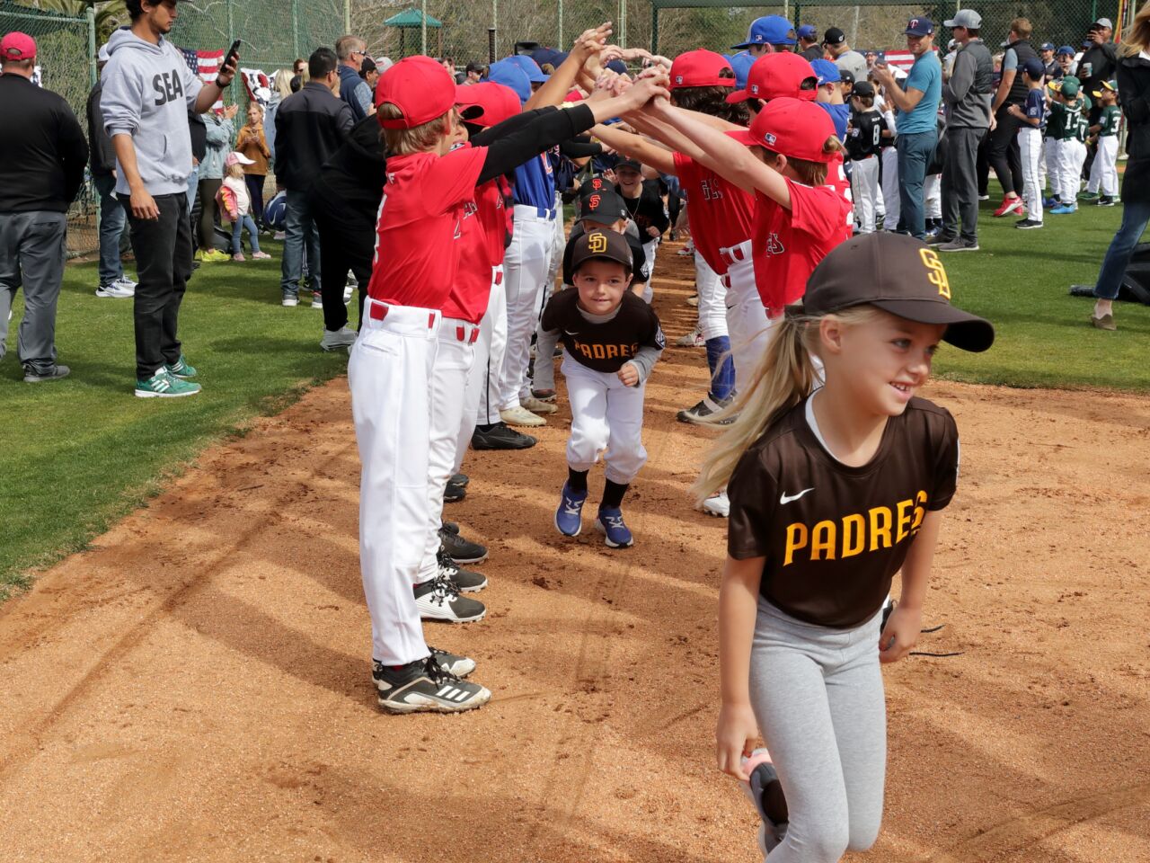 RSFLL players form a tunnel to welcome the newest T-Ball players