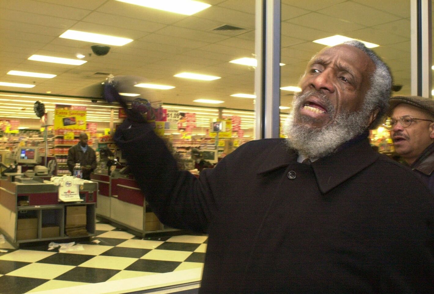 Dick Gregory leads a protest march at Kroger Food and Pharmacy in 2001 in Royal Oak Township, Mich., after Travis Shelton died during a struggle with store security guards who suspected Shelton of shoplifting.