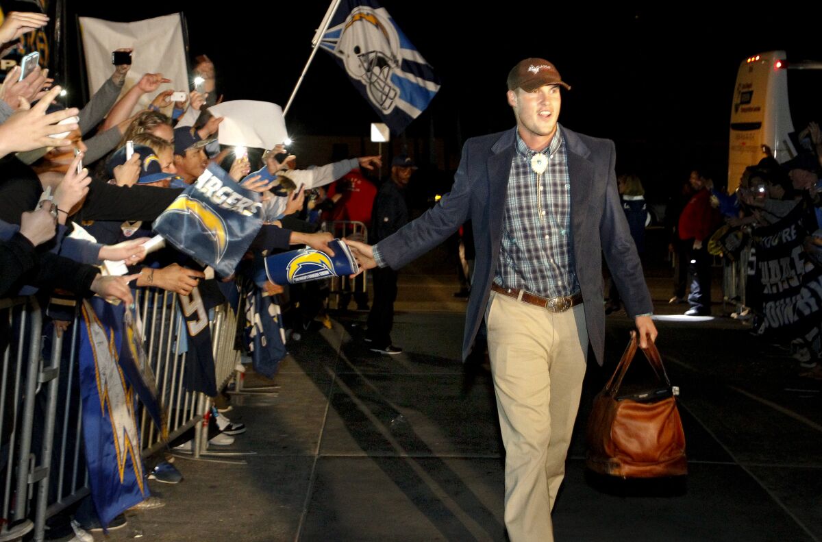Philip Rivers, wearing a bolo tie, arrives at Chargers Park after the San Diego Chargers won a playoff game in January 2014.
