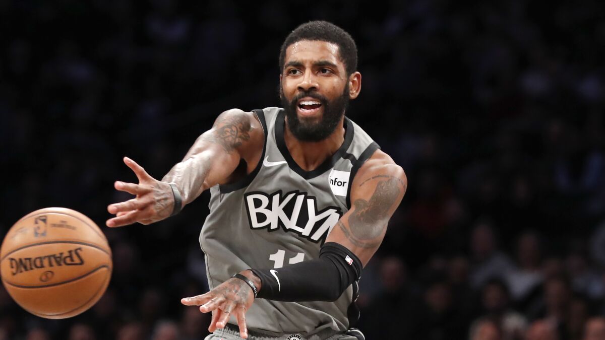Brooklyn Nets guard Kyrie Irving passes the ball during a game against the Knicks in New York.