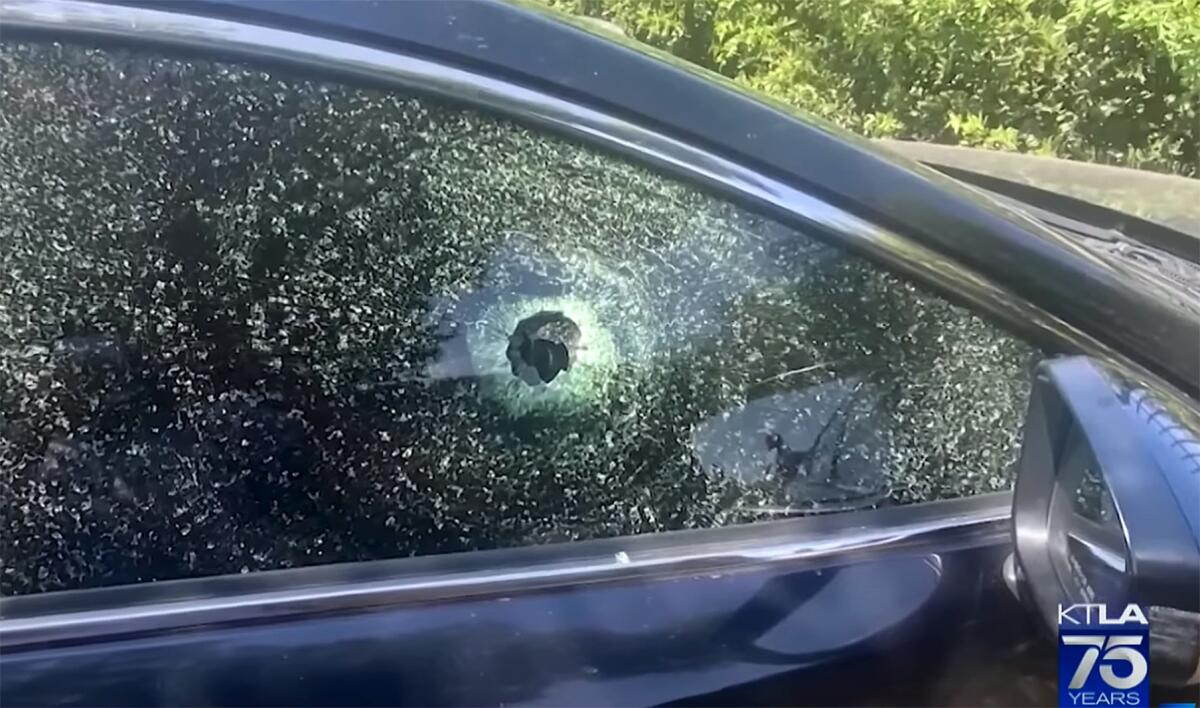 Car window shattered by a bullet.