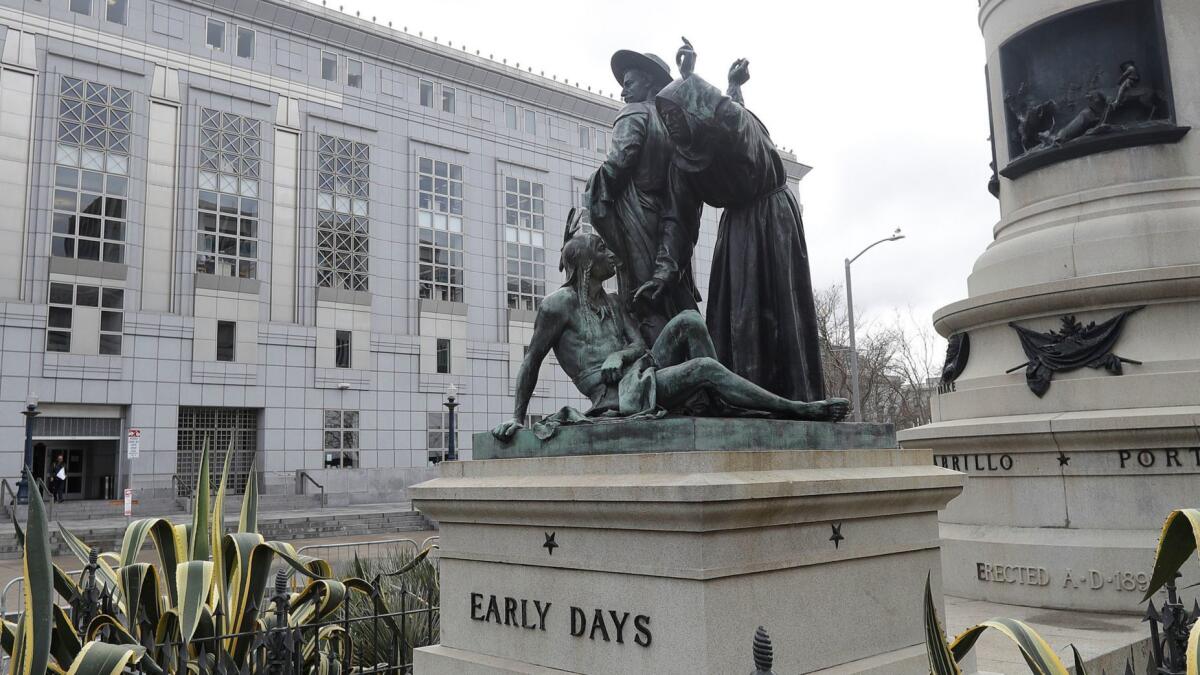 The "Early Days" statue depicts a Native American at the feet of a Spanish cowboy and a Catholic missionary.