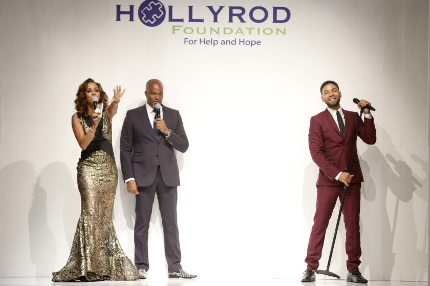 Holly Robinson Peete, left, Chris Spencer and singer Jussie Smollett appear onstage at the HollyRod Foundation's 17th annual DesignCare Gala.
