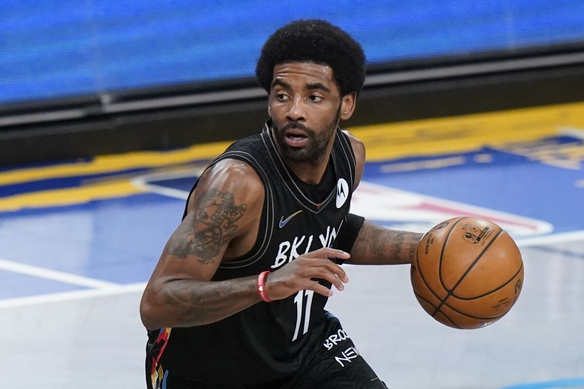 The Brooklyn Nets' Kyrie Irving handles the ball in May 2021.