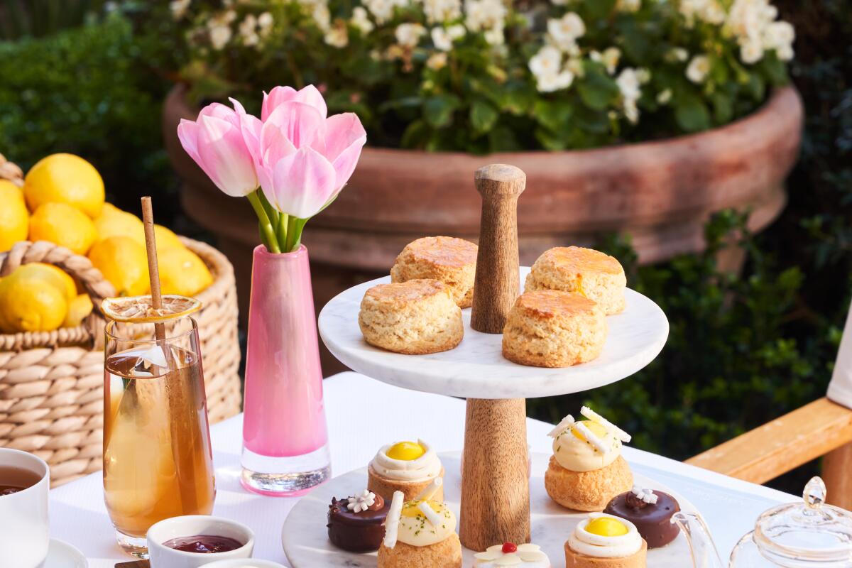 tiered pastry tray with teas on a table outside 