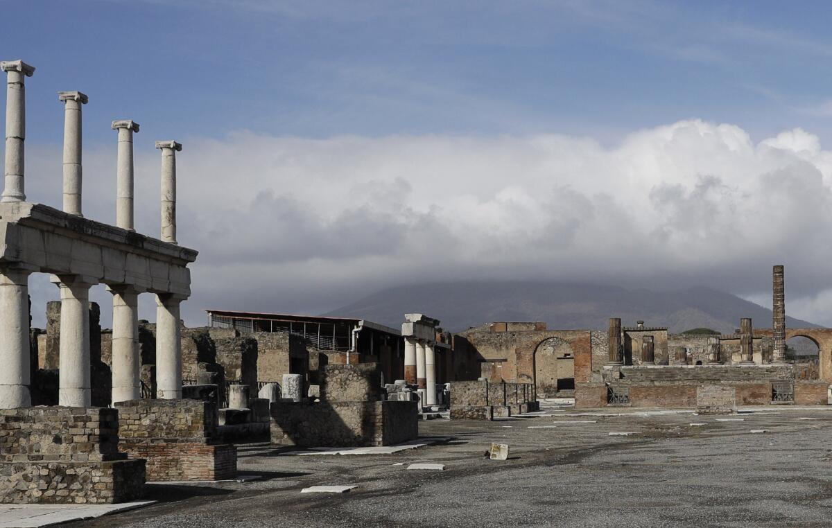 FILE - Clouds hang over the Vesuvius volcano in Pompeii, southern Italy, Jan. 25, 2021. An American tourist had to be rescued on Mount Vesuvius near Naples after he apparently slipped into the volcano’s crater while trying to recover his fallen cellphone, news reports and the association of Vesuvius park guides said. The tourist and family members were cited by Carabinieri police because they went off the authorized path to get closer to the crater on Saturday, July 9, 2022 apparently to take a selfie, Italian news reports said. (AP Photo/Gregorio Borgia, file)