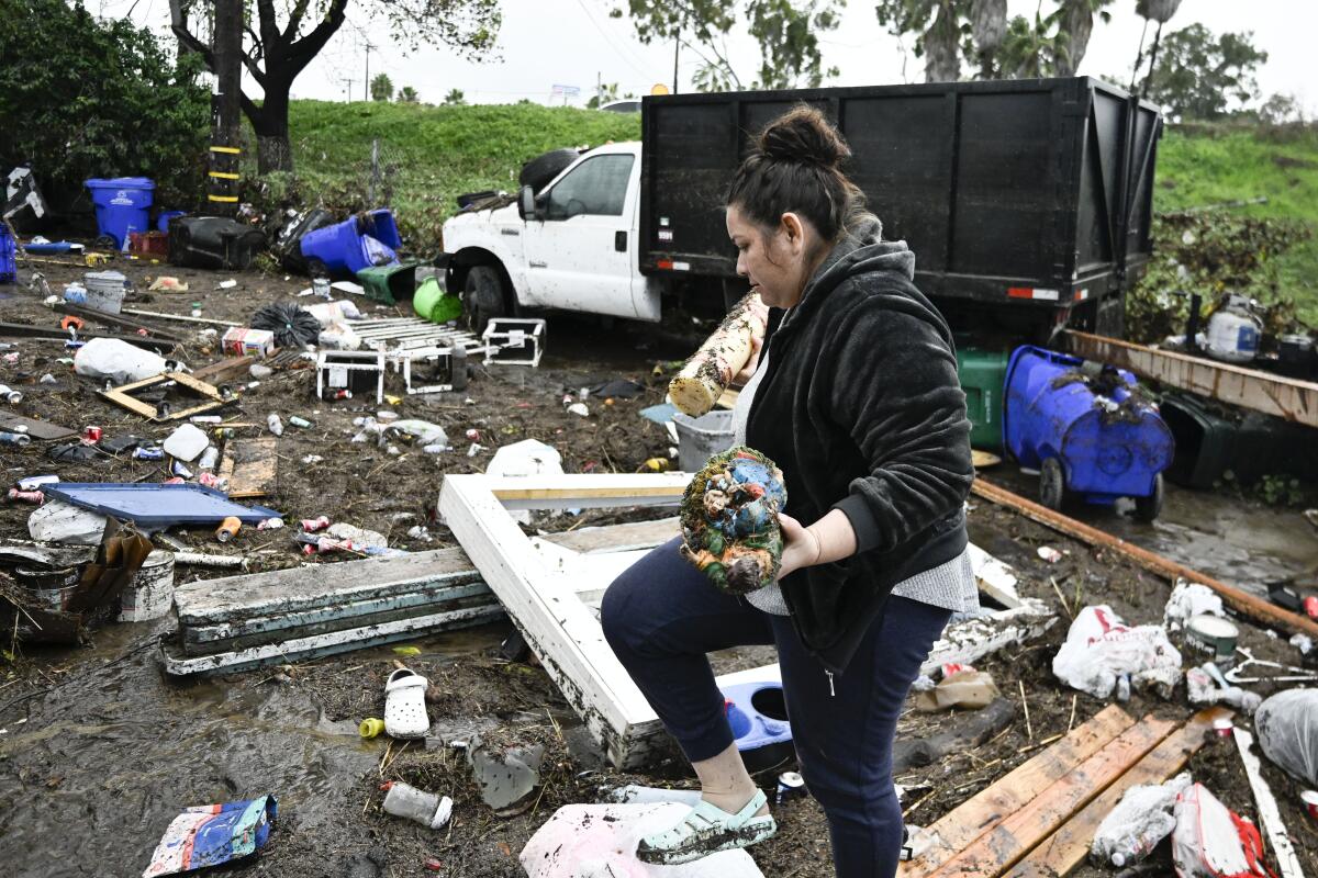 Marlene Sanchez-Barriento salvages items behind her home 
