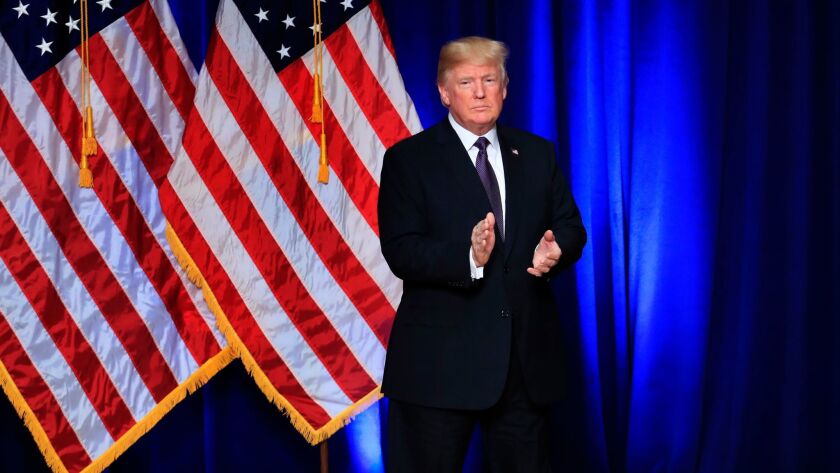 President Donald Trump applauds after a speech in Washington on Dec. 18.