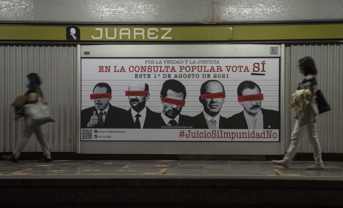 Commuters walk past an advertisement showing images of several Mexican former presidents, obscuring their eyes with red bars, and calling for citizens to participate in a referendum on whether ex-presidents should be tried for their alleged crimes during their time in office, in Mexico City, Saturday, July 31, 2021. The yes-or-no referendum on Sunday is going to cost Mexico about $25 million, and the vote is being held in the middle of a third wave of the coronavirus pandemic. (AP Photo/Christian Palma)