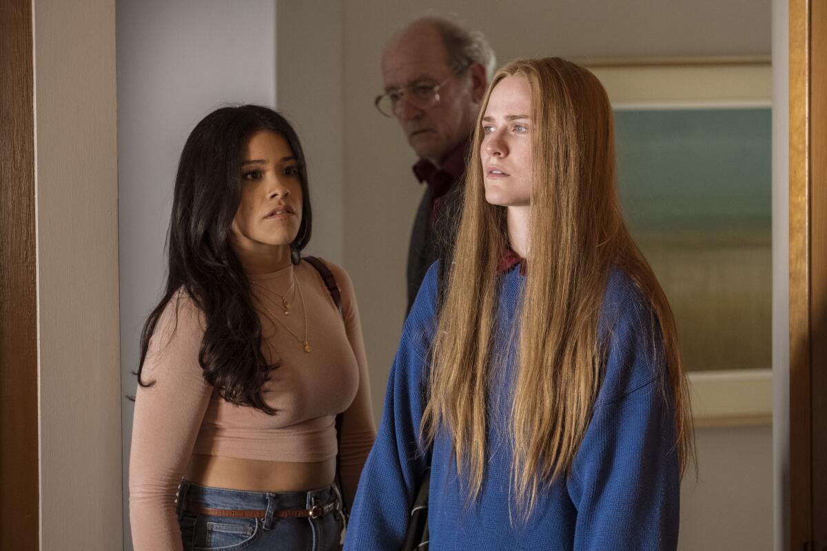 Gina Rodriguez, left, Richard Jenkins and Evan Rachel Wood in "Kajillionaire."