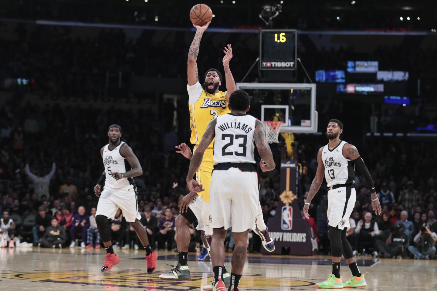 Lakers forward Anthony Davis attempts a three-point shot on the run to end the first half.