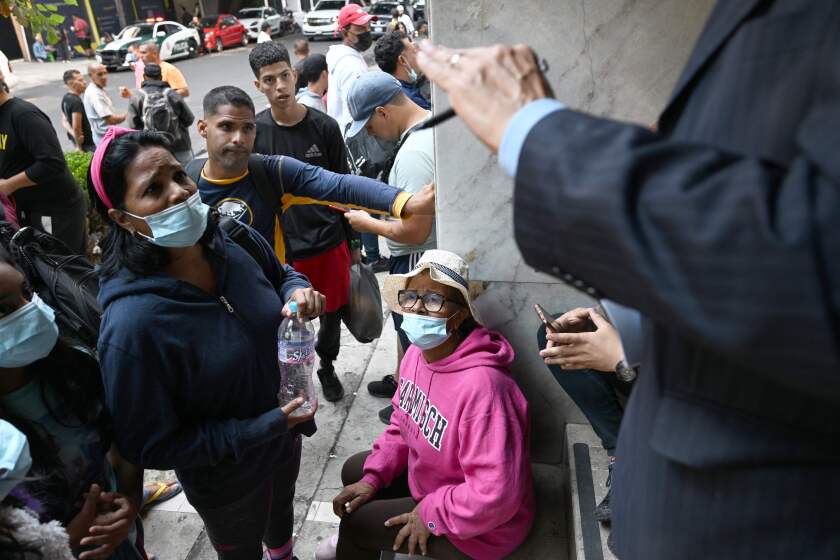 Venezuelan migrant Zuahil Vi?oles (L) and her mother (R) receive information on how to return to their country, outside the Venezuelan embassy in Mexico City on October 25, 2022. - Earlier this month the US announced a new program granting legal entry to 24,000 people from the crisis-wracked country while deporting all those who cross through the border with Mexico illegally. The agreement between the US and Mexico would allow 24,000 Venezuelans to enter the United States if they can prove they have sponsorship, and only if they fly into the country. (Photo by Rodrigo ARANGUA / AFP) (Photo by RODRIGO ARANGUA/AFP via Getty Images)