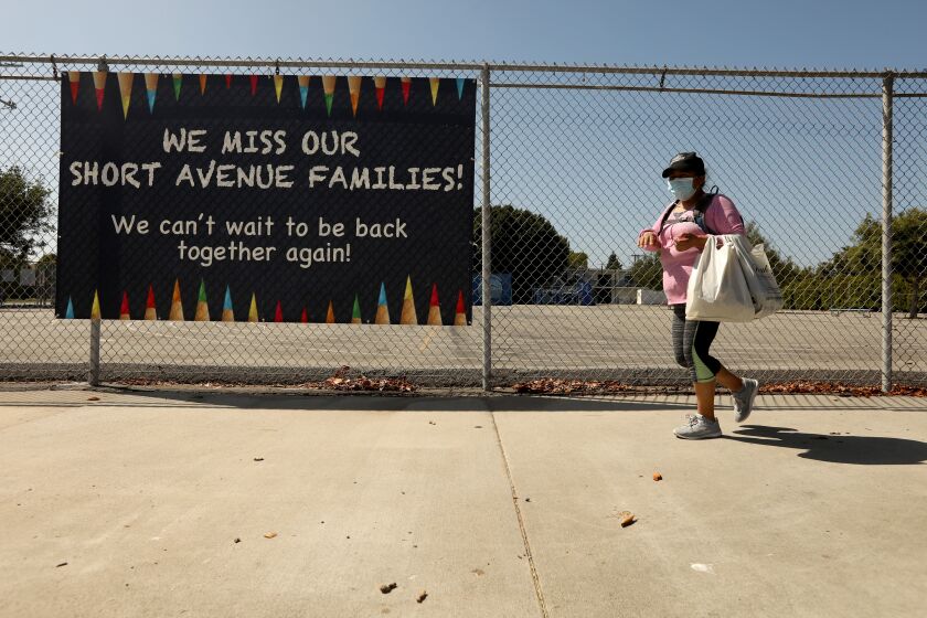 MAR VISTA, CA - JULY 13, 2020 - - A sign states, "We miss our Short Avenue Families," at the closed Short Avenue Elementary School in Mar Vista on July 13, 2020. Los Angeles campuses will not reopen for classes on Aug. 18, and the nation's second-largest school system will continue with online learning until further notice, because of the worsening coronavirus surge, Supt. Austin Beutner announced Monday. "Let me be crystal clear," Beutner said in an interview with The Times. "We all know the best place for students to learn is in a school setting." But, he said, "We're going in the wrong direction. And as much as we want to be back at schools and have students back at schools - can't do it until it's safe and appropriate." (Genaro Molina / Los Angeles Times)