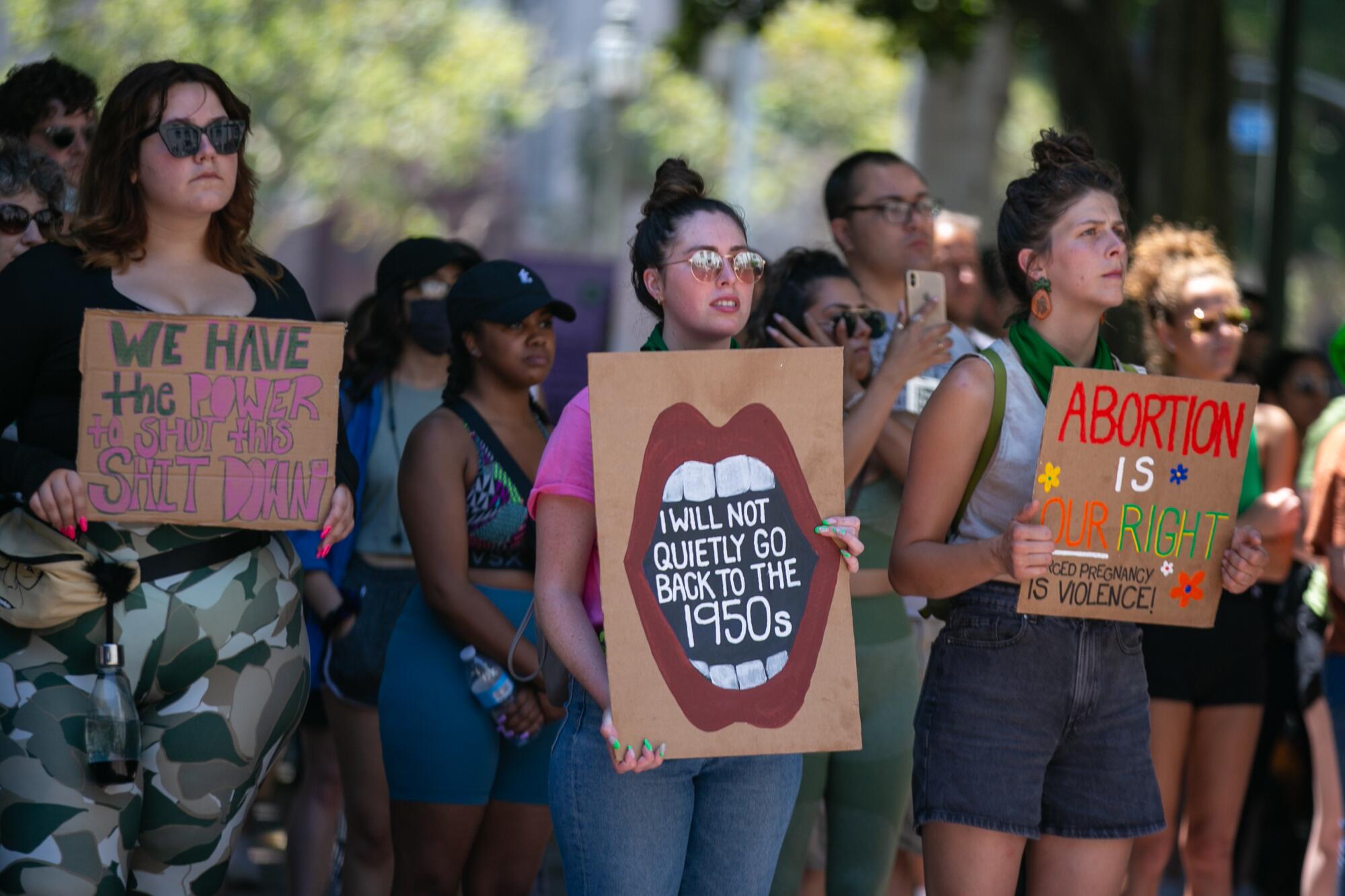 People hold signs.