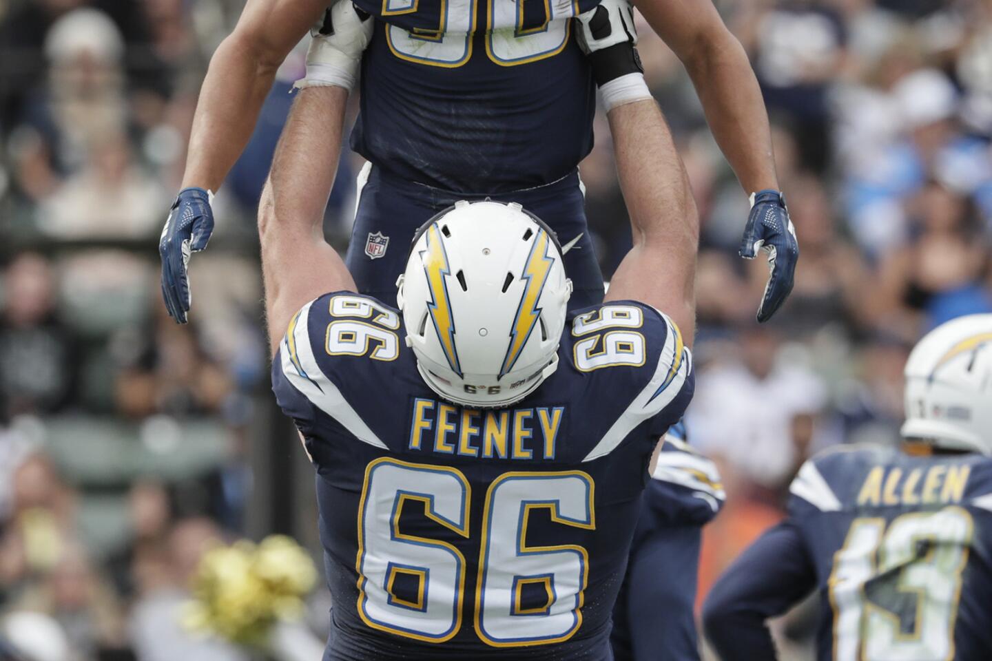 Chargers running back Austin Ekeler is lifted by offensive lineman Dan Feeney after Ekeler scored during the second quarter.
