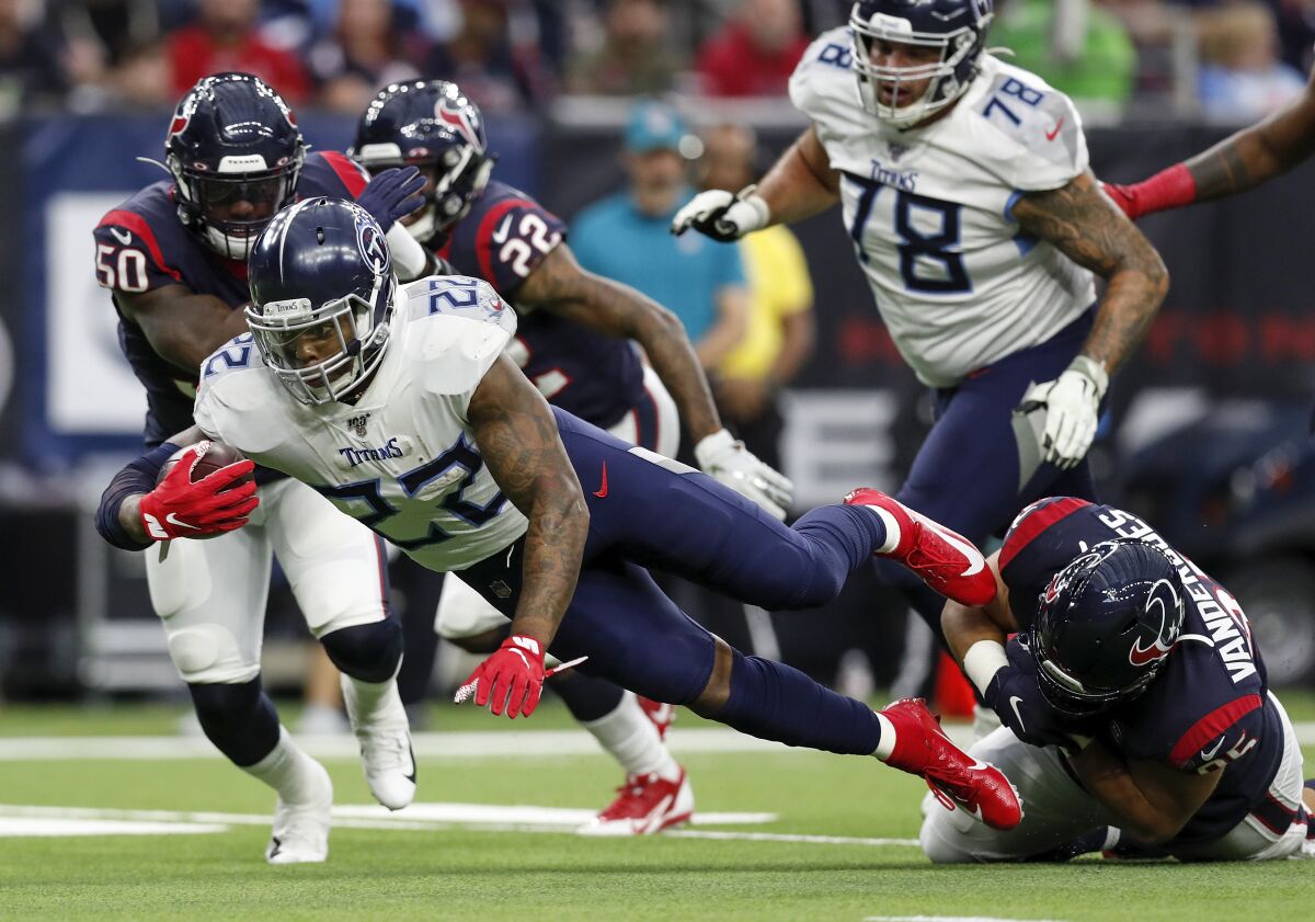 Tennessee Titans running back Derrick Henry dives for a first down Sunday against the Houston Texans.