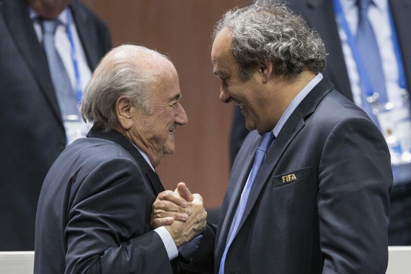 FIFA President Sepp Blatter, left, is congratulated by UEFA President Michel Platini after Blatter's reelection in Zurich on May 29.
