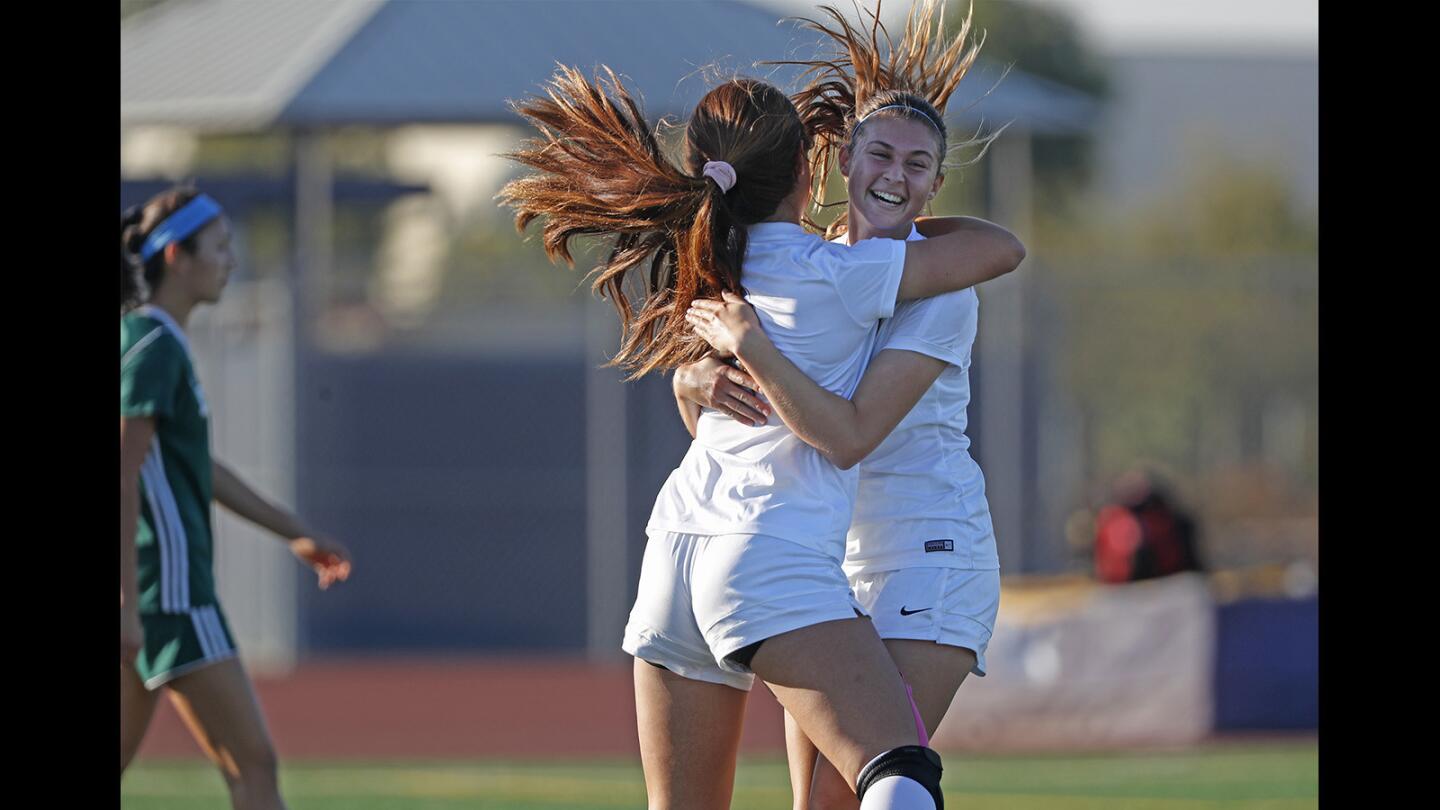 Marina High's Lori Mandarino, right, is congratulated by teammate Kellie Hallworth on scoring a goal against Edison during the first half in a Sunset League match on Thursday.