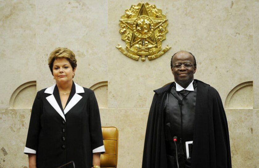 Brazilian President Dilma Rousseff, left, with Joaquim Barbosa during his inauguration as Brazil's first black head of the Supreme Court.