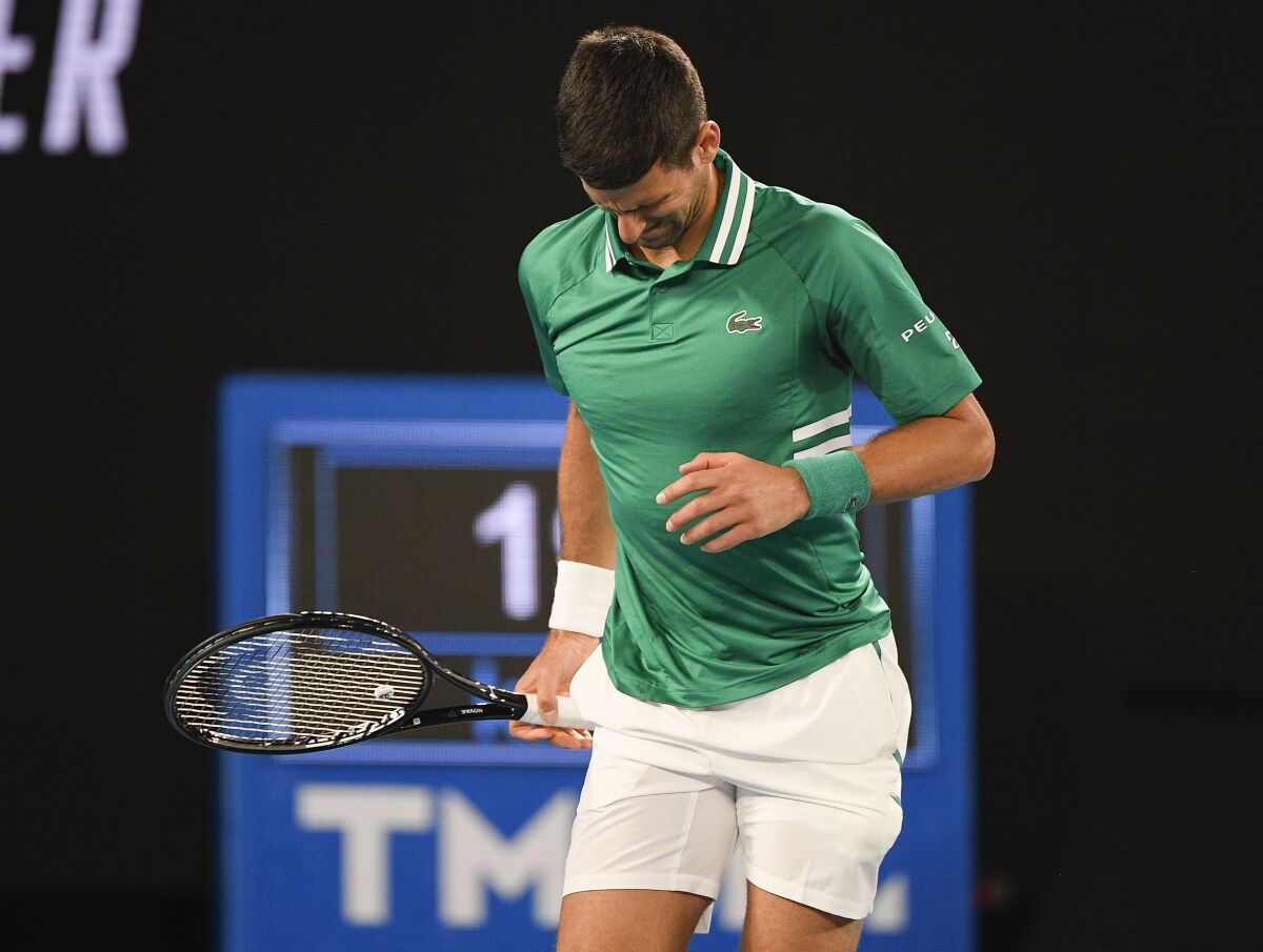 Novak Djokovic grimaces on court