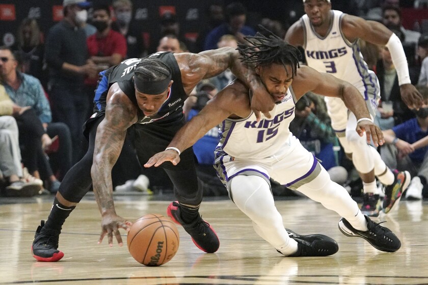 Los Angeles Clippers guard Eric Bledsoe, left, and Sacramento Kings guard Davion Mitchell go after a loose ball during the first half of an NBA basketball game Wednesday, Dec. 1, 2021, in Los Angeles. (AP Photo/Mark J. Terrill)