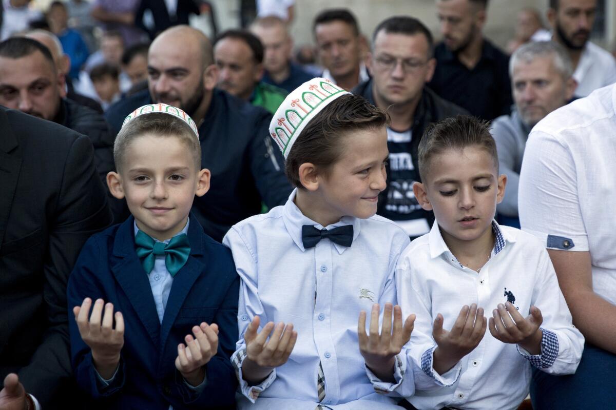 Kosovo: Boys pray to mark the first day of Eid al-Adha outside the Sultan Mehmet Fatih mosque in Pristina.