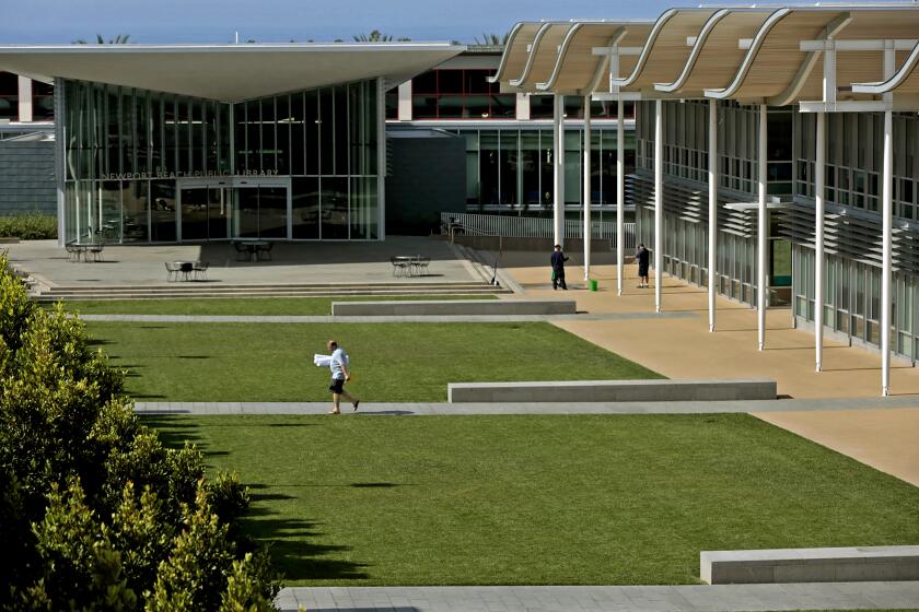 NEWPORT BEACH, CA., APRIL 3, 2015: A pedestrian walks past the lawns between city hall and the public library in Newport Beach April 3, 2015. Newport Beach is one of the heaviest per-capita water using cities in the state and will have to cut use by the end of Feb 2016 under the executive order given by Governor Brown (Mark Boster/Los Angeles Times).