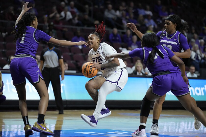 Stephen F. Austin's Zya Nugent (22) drives against Grand Canyon during the first half of an NCAA college basketball game for the championship of the Western Athletic Conference women's tournament Saturday, March 12, 2022, in Las Vegas. (AP Photo/John Locher)