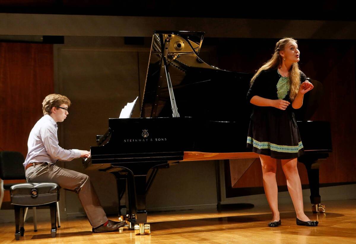 Soprano Erika Baikoff sings "Air Champetre" as Evan Roider plays piano as student musicians rehearse at "A Songfest" program master class taught by Lisa Saffer at the Colburn School in Los Angeles on July 1, 2013.