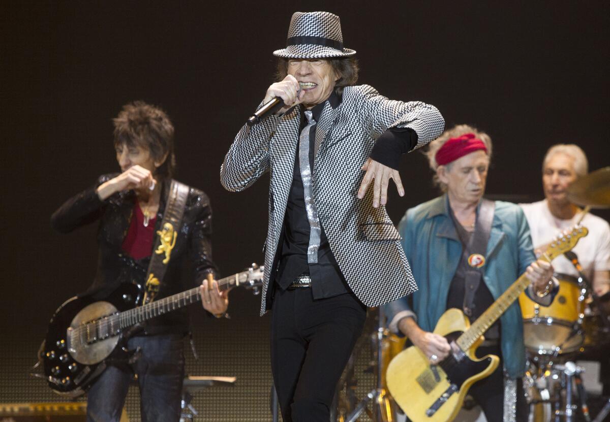 Mick Jagger, center, Keith Richards, Ronnie Wood, left, and Charlie Watts, right, of the Rolling Stones perform in London. The Rolling Stones will return to the road for a 2013 tour.