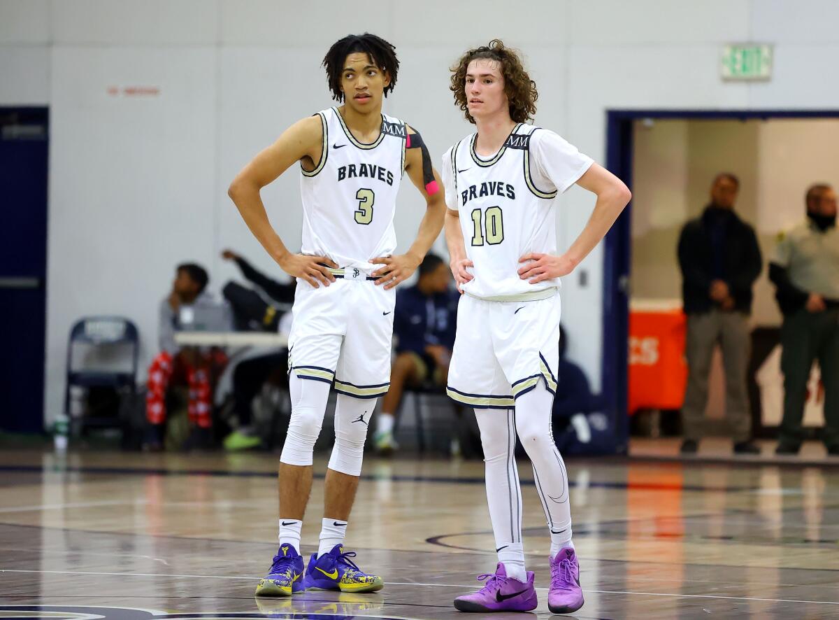 St. John Bosco High teammates Elzie Harrington (left) and Jack Turner confer on the court during a break in play.