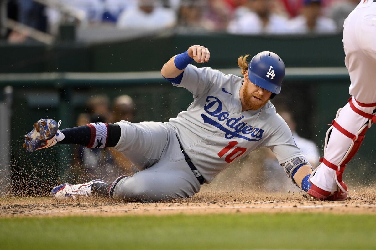 Dodgers third baseman Justin Turner slides into home to score a run against the Washington Nationals on July 3.