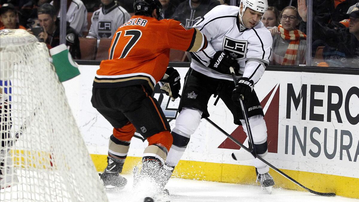 Kings left wing Milan Lucic centers the puck past Ducks center Ryan Kesler, left, during the first period of a game on Jan. 17.