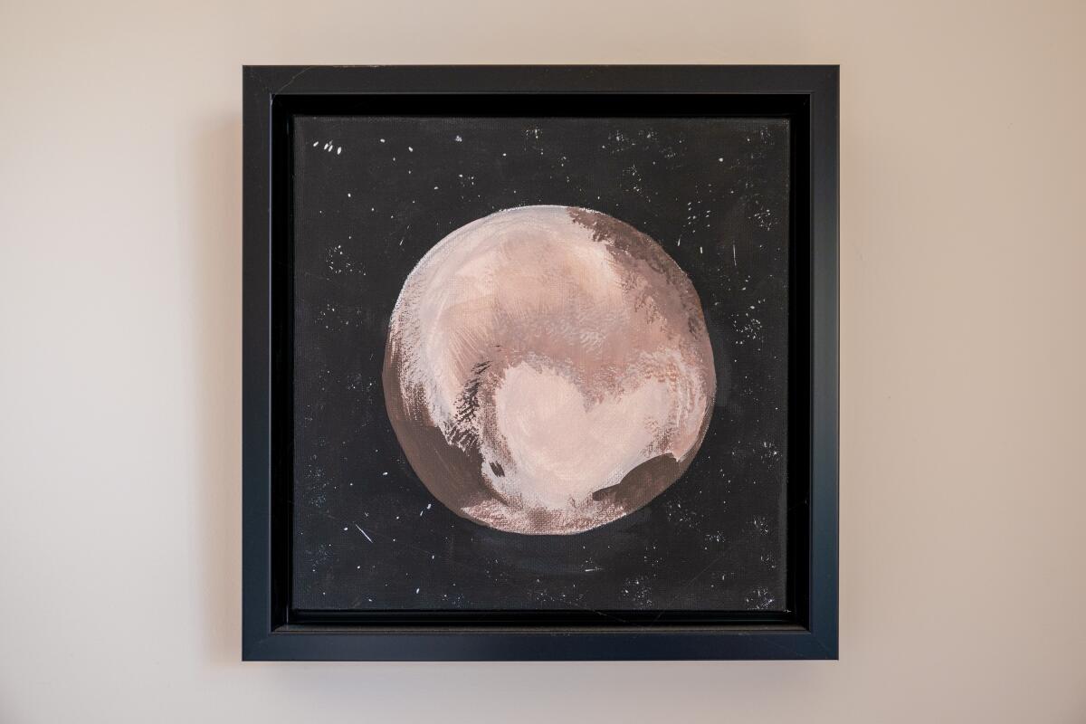 Ruby Campbell's painting of Pluto hangs on the wall.