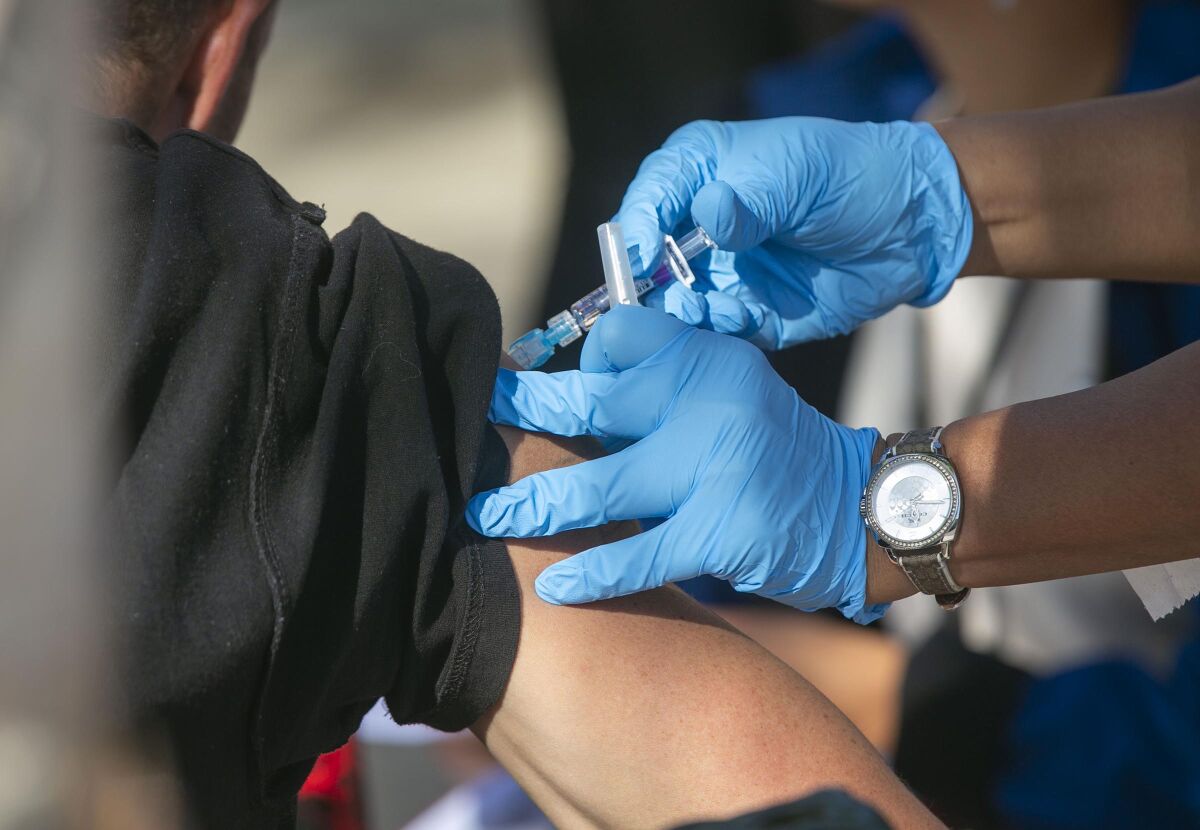 A man receives a flu vaccine shot in Spring Valley, Calif., in 2019. 