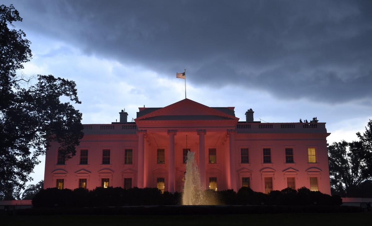 The White House is lit in pink in honor of breast cancer awareness month on Oct. 9.