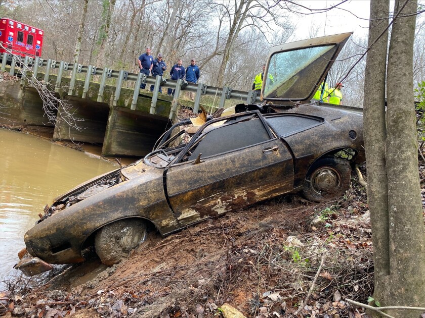 In this December 2021 photo provided by the Chambers County Sheriff's Department, the 1974 Pinto Kyle Clinkscales was driving when he disappeared in 1976, is recovered from a creek in Alabama. Sheriff's officials have previously said Clinkscales was killed, but now are raising the possibility that he went off the road and crashed. (Maj. Terry "Tj" Wood/Chambers County Sheriff's Department via AP)