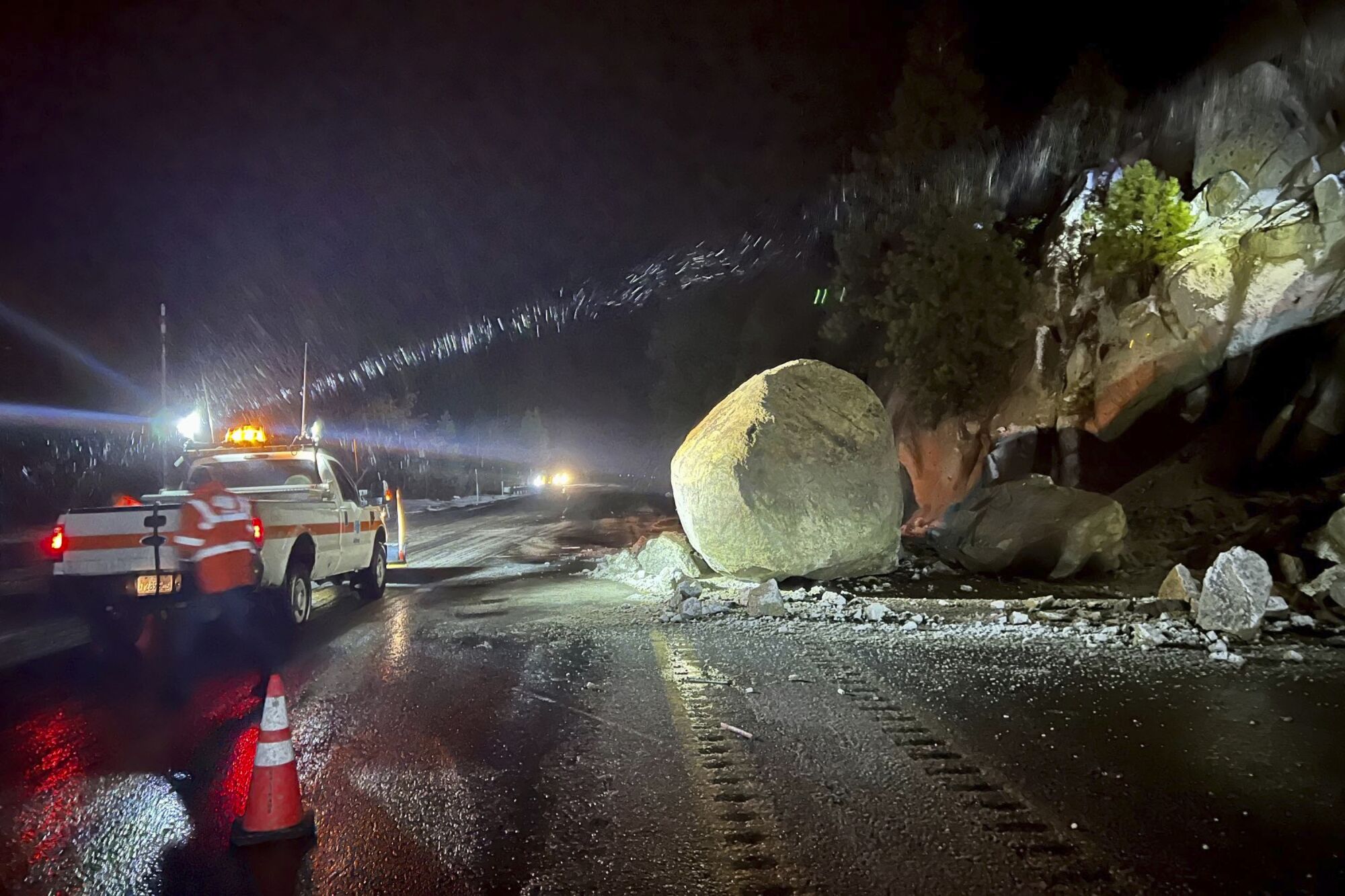 Caltrans crews check large boulders that fell onto Highway 50.
