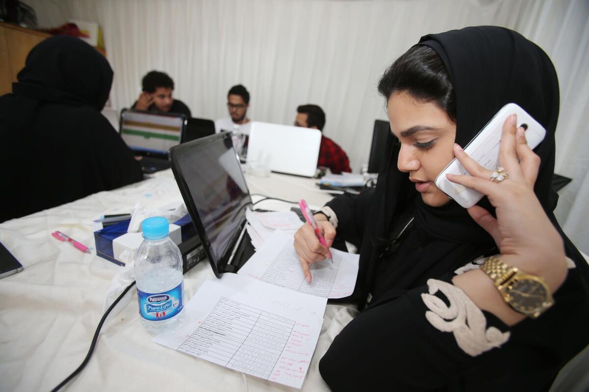 Communication staff members for the campaign of a female candidate in the Saudi municipal elections contact voters in Jidda.